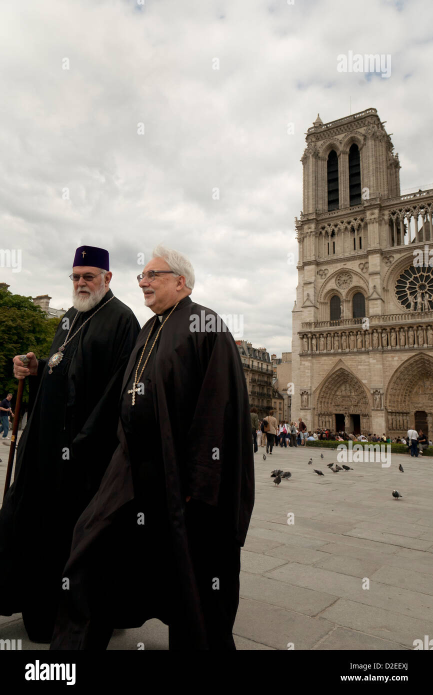 Two priests outside Notre Dame cathedral in Paris, France Stock Photo