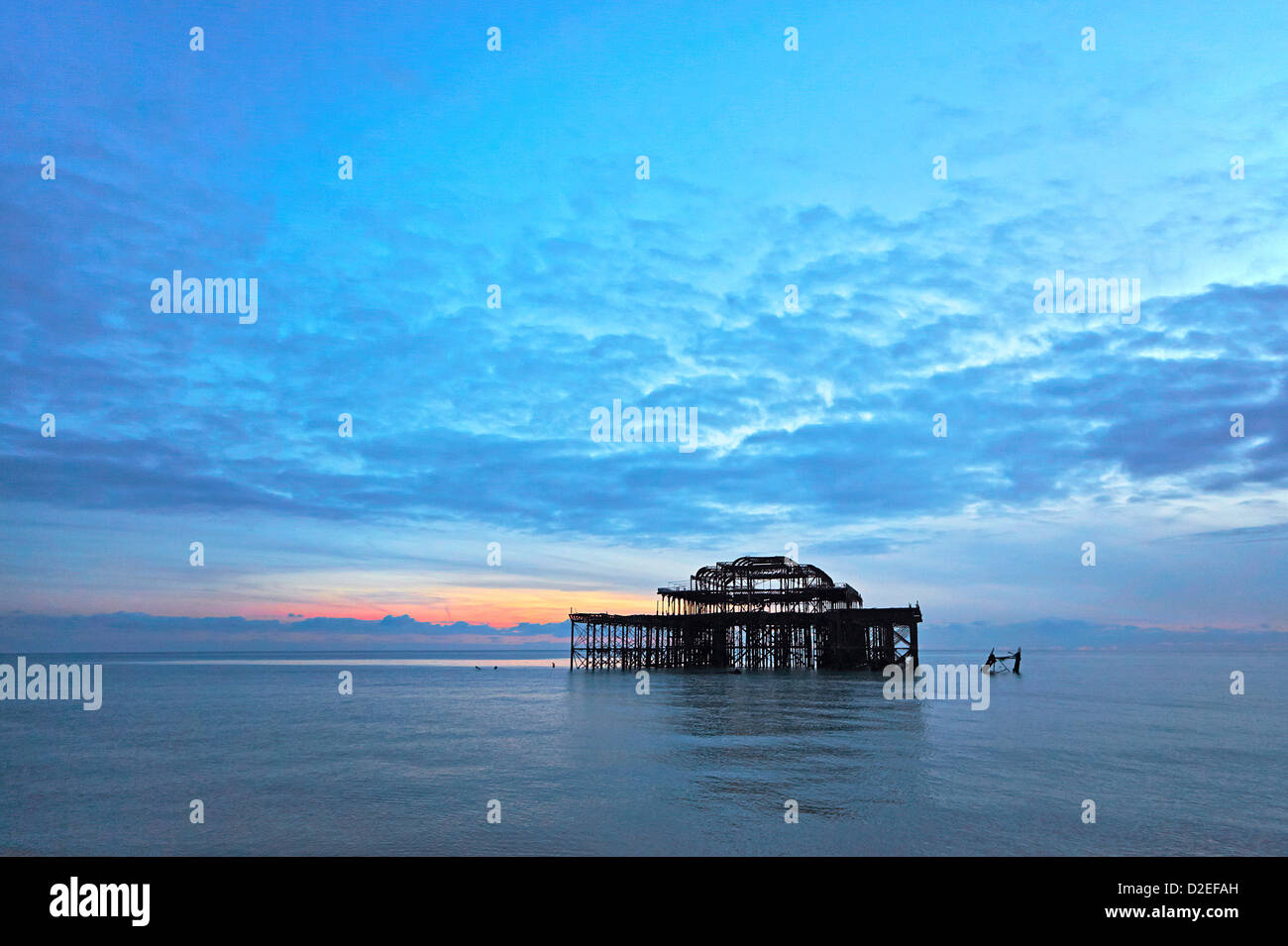 Brighton iconic West pier skeletal remains damaged by fire and storms taken at sunset Stock Photo