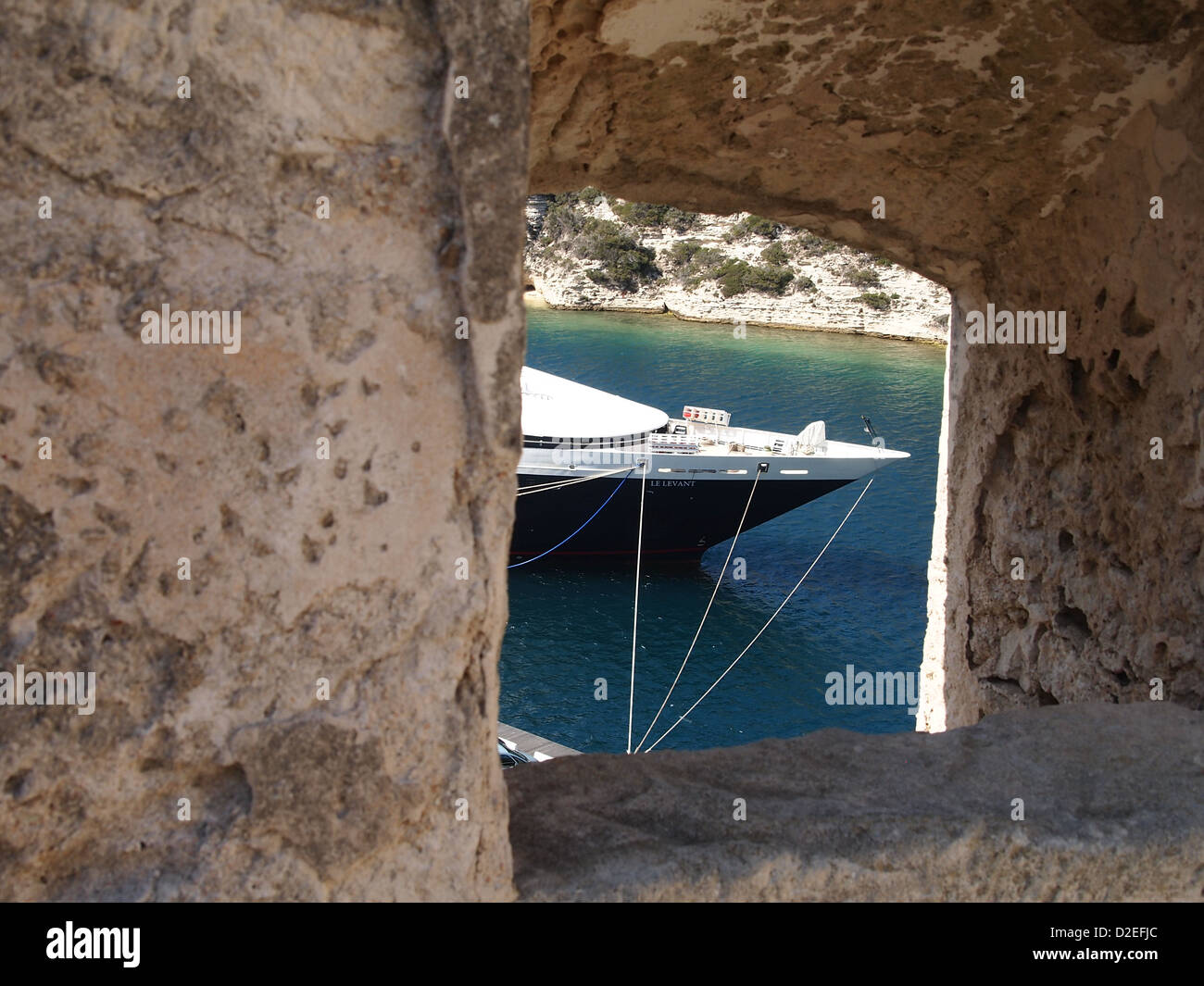 A view at a beak of a nice ship through a small stony window Stock Photo