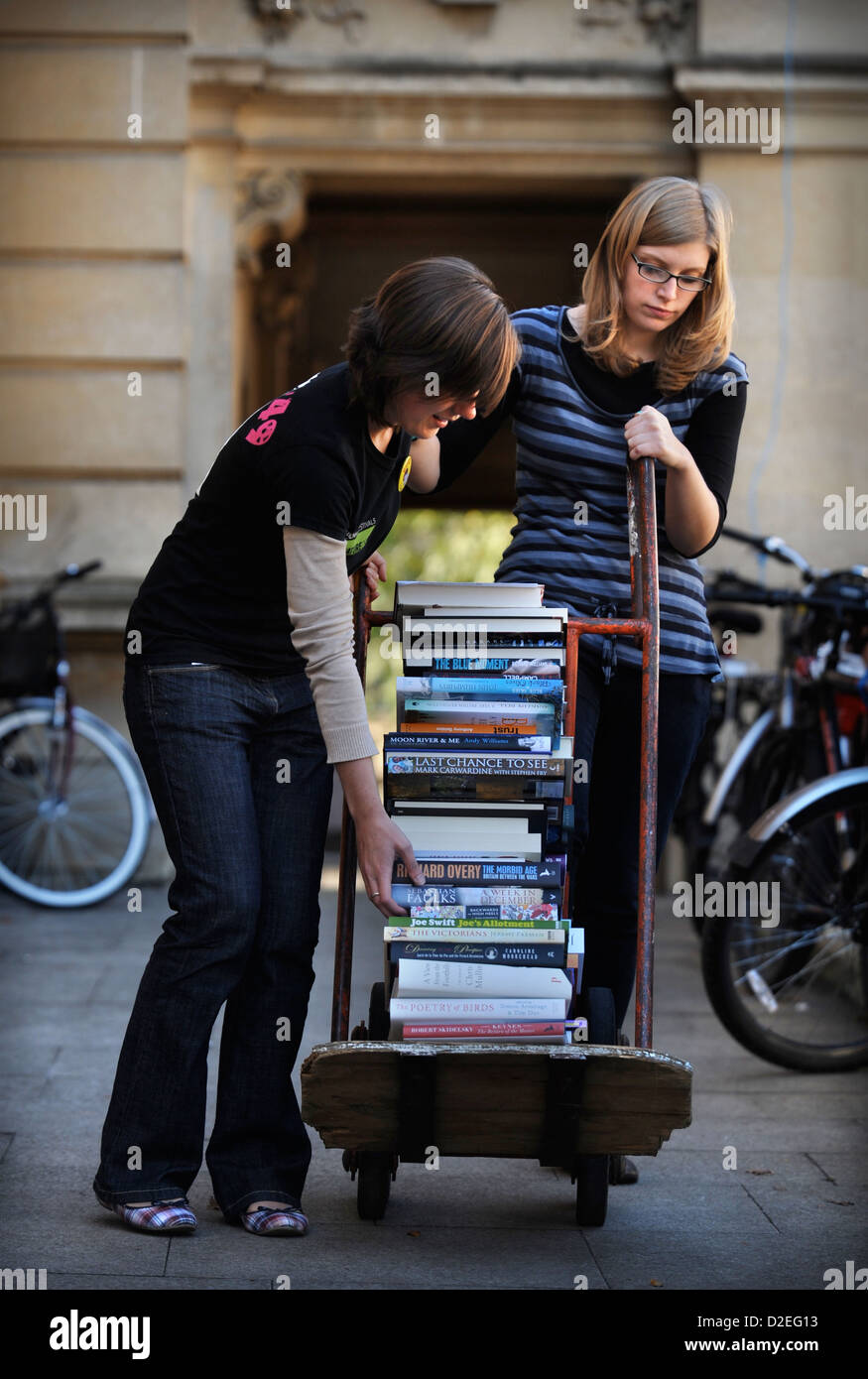 Festival organisers manoeuvre a stack of books on a sack truck at the Cheltenham Literature Festival UK Stock Photo
