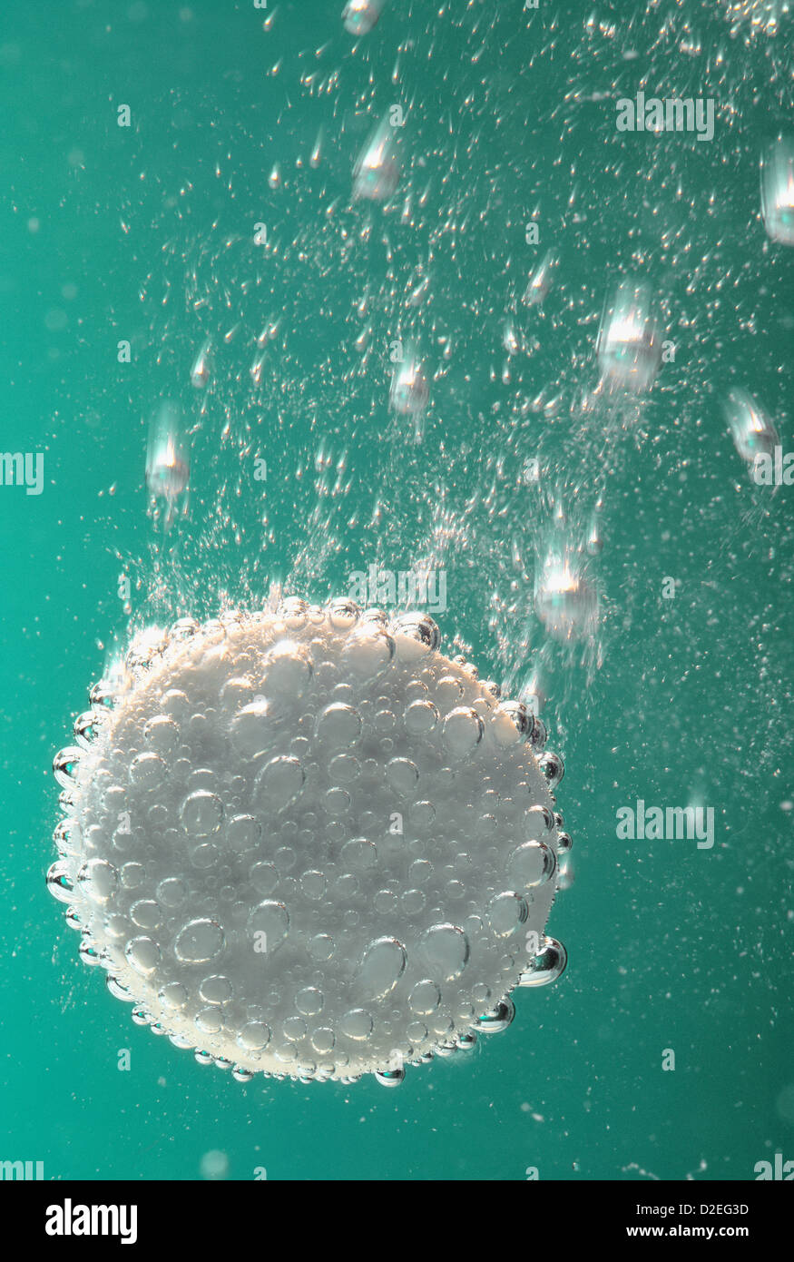 soluble tablet in water, bubbles, green background, portrait Stock Photo