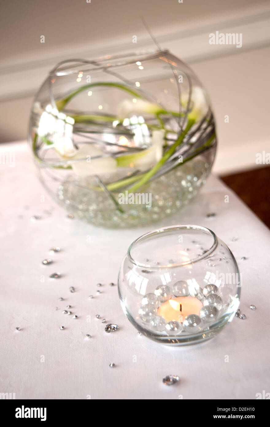 Candles and flowers in bowls to decorate a table at a wedding Stock Photo