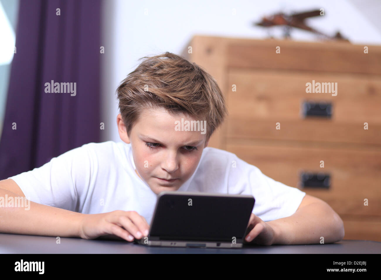 France, boy with Nintendo DS Stock Photo