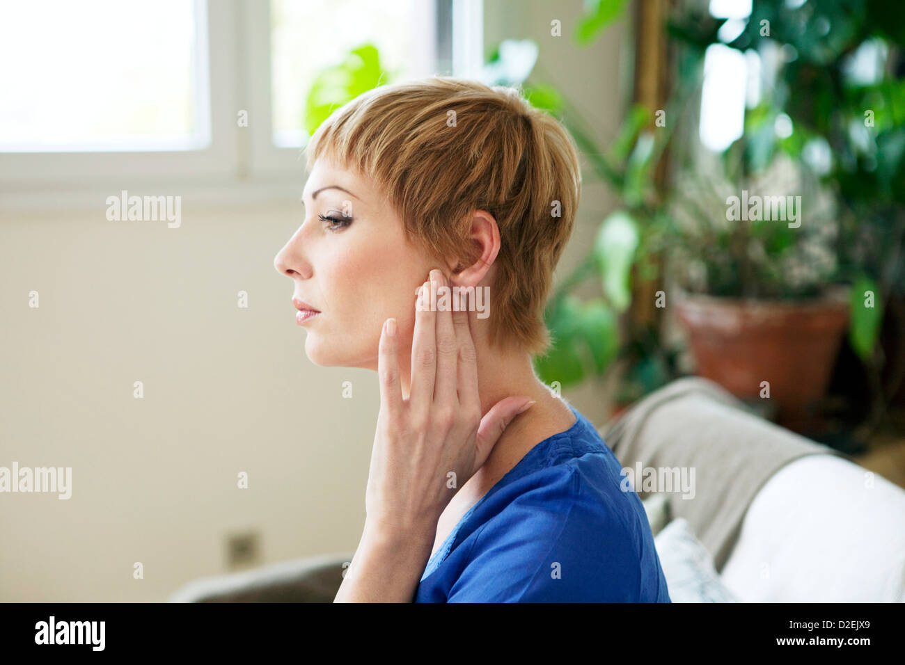 EAR PAIN IN A WOMAN Stock Photo