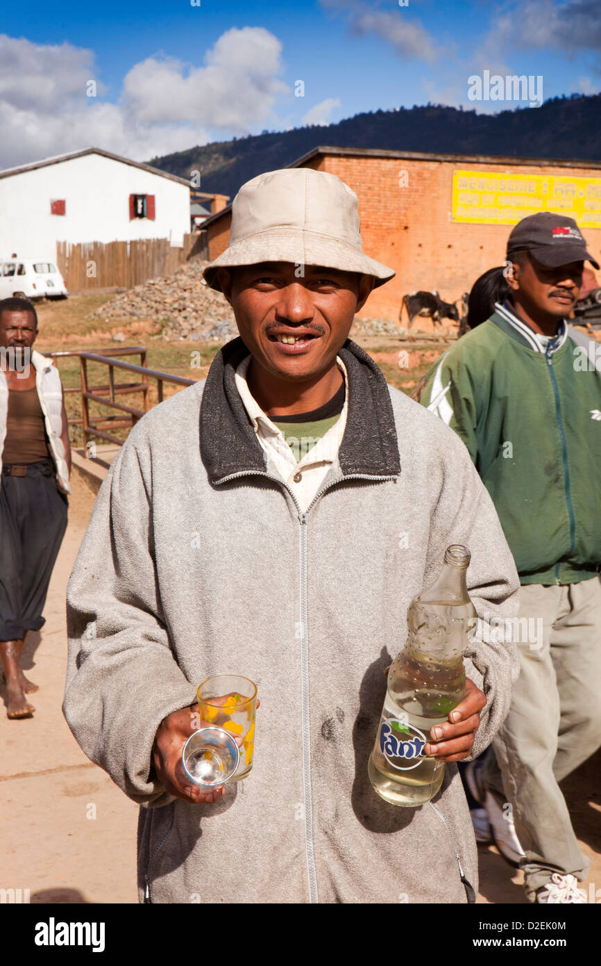 Madagascar, Ambositra, Savika Zebu running, man with bottle of local rum for courage Stock Photo