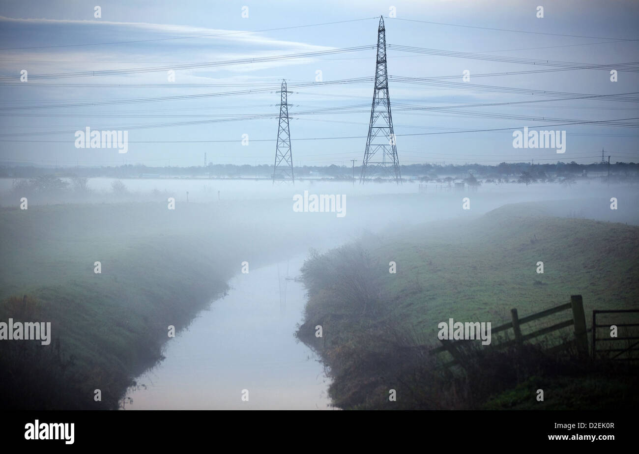 Morning mist over the fields that bank the River goyt in Ellesmere Port Cheshire, The M56 motorway is running on the horizon jus Stock Photo