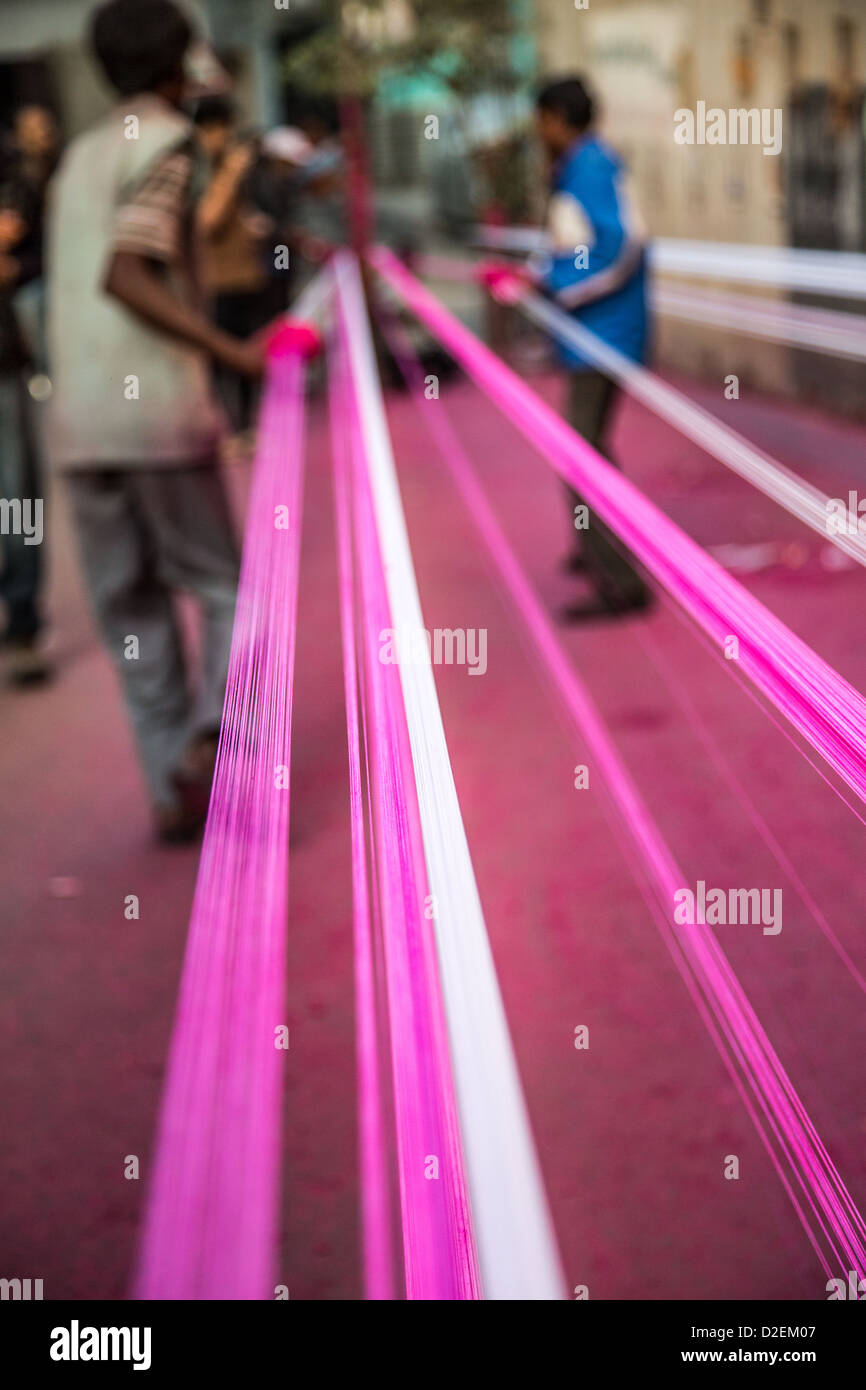 Coating kite string with ground glass for the Kite Festival or Uttarayan in Ahmedabad, Gujarat, India Stock Photo