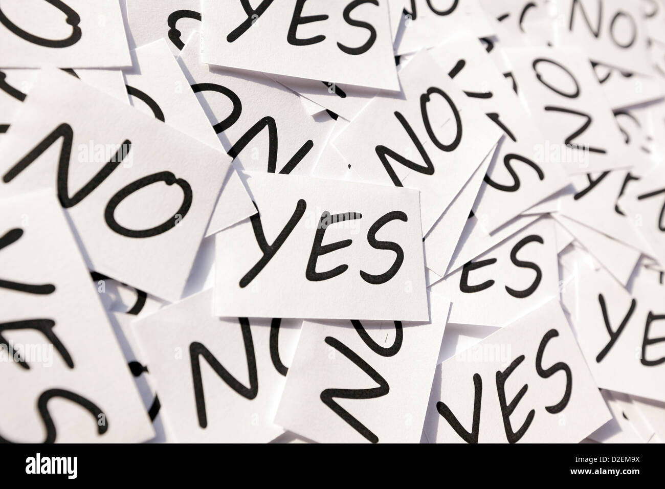 Yes's and No's written on papers on white background. Stock Photo