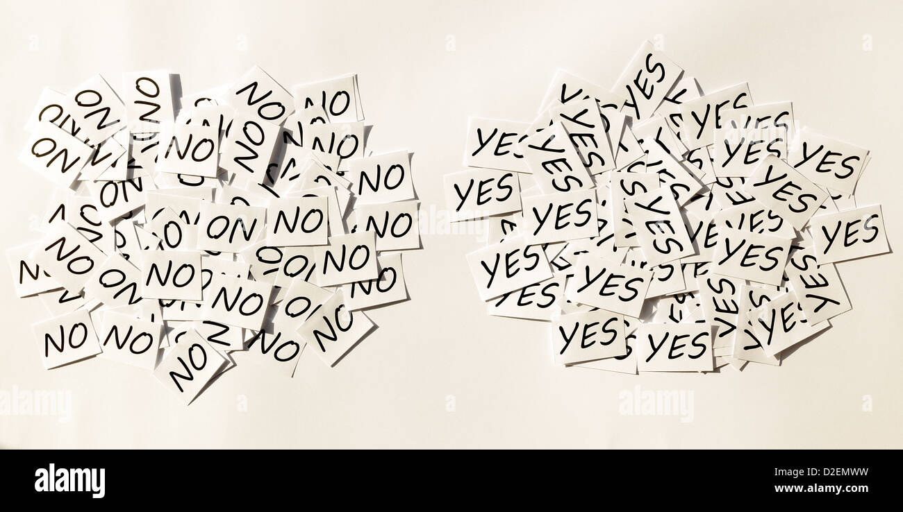 Yes's and No's written on papers on white background. Stock Photo