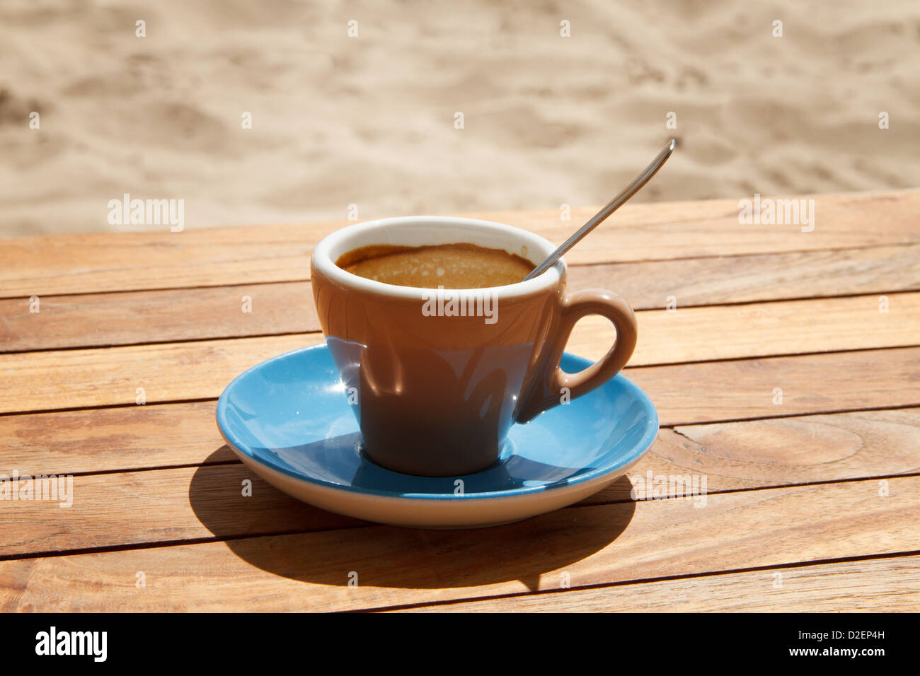 A cup of coffee on a wooden table. Stock Photo