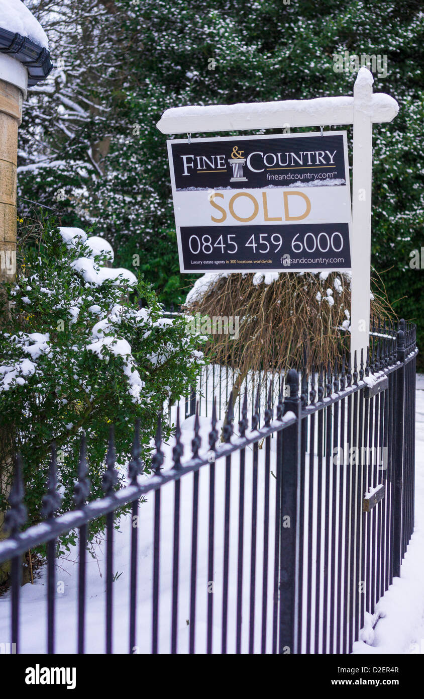 A country house sold sign in winter. Stock Photo