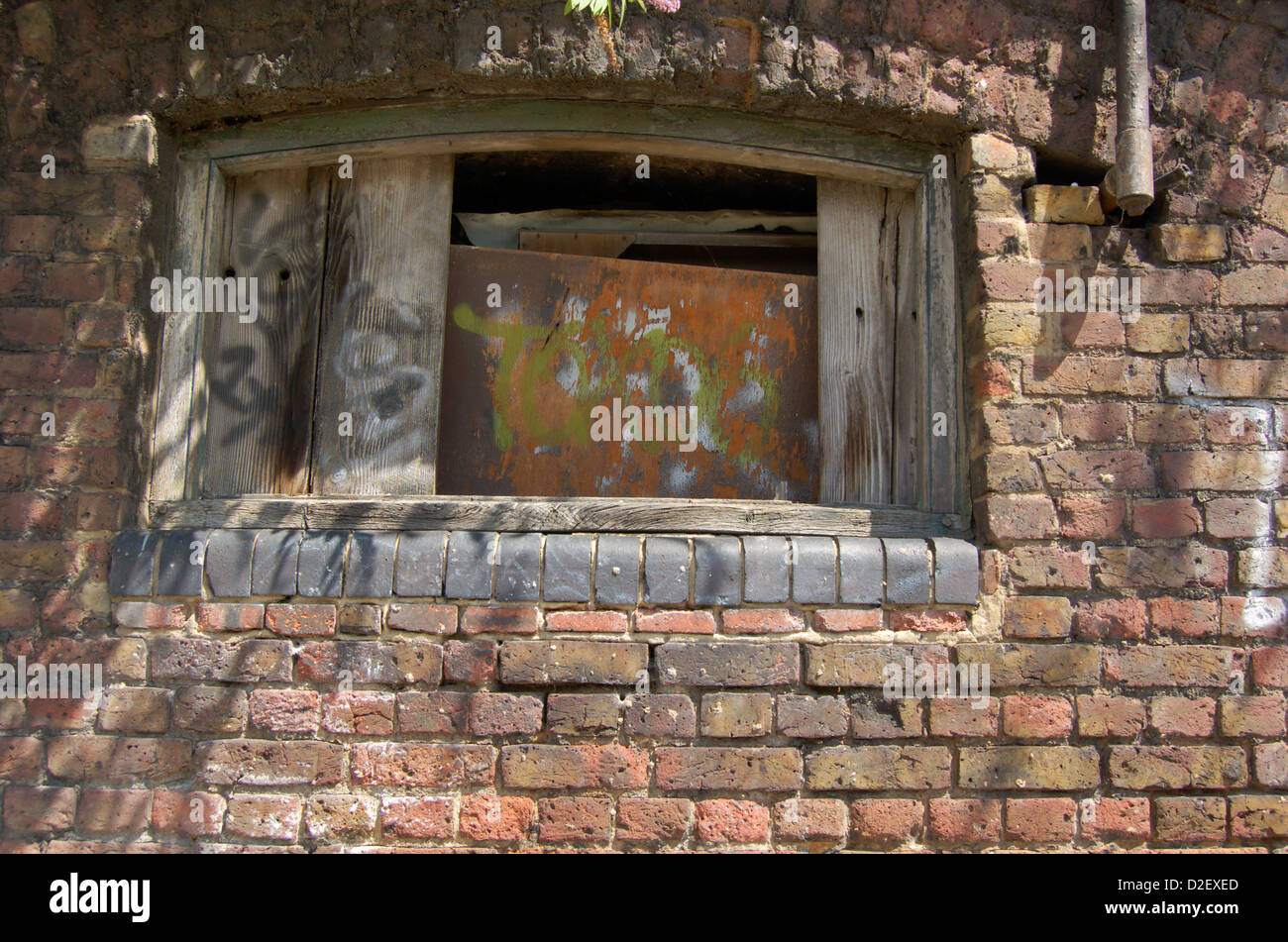 Close up of brick wall and boarded window Stock Photo - Alamy