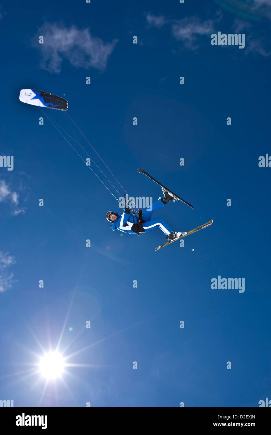 Man kite skiing against blue sky in Austria Stock Photo