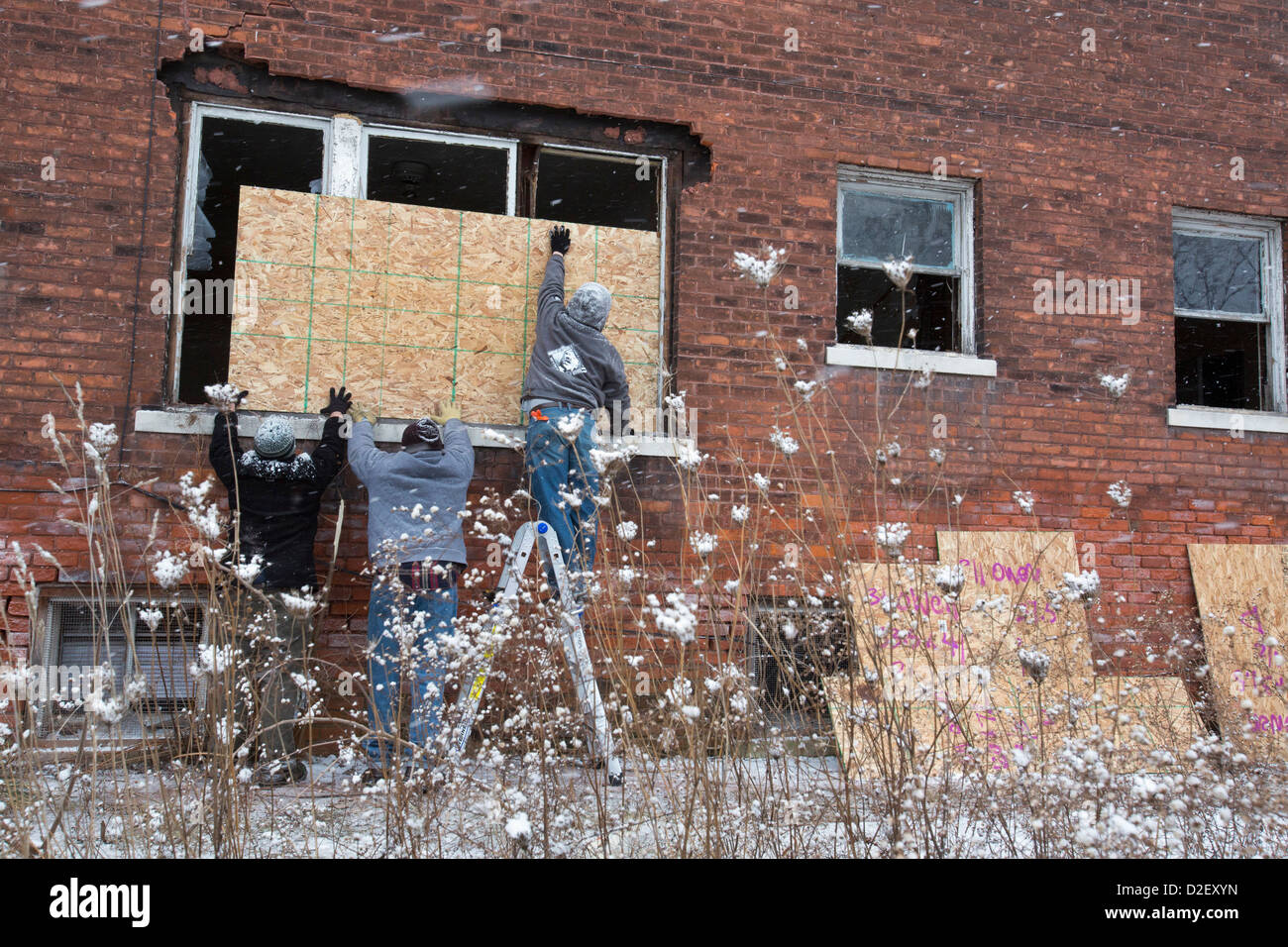 On Martin Luther King Jr. Day, volunteers from Wayne State University and neighborhood residents boarded up abandoned houses. Stock Photo