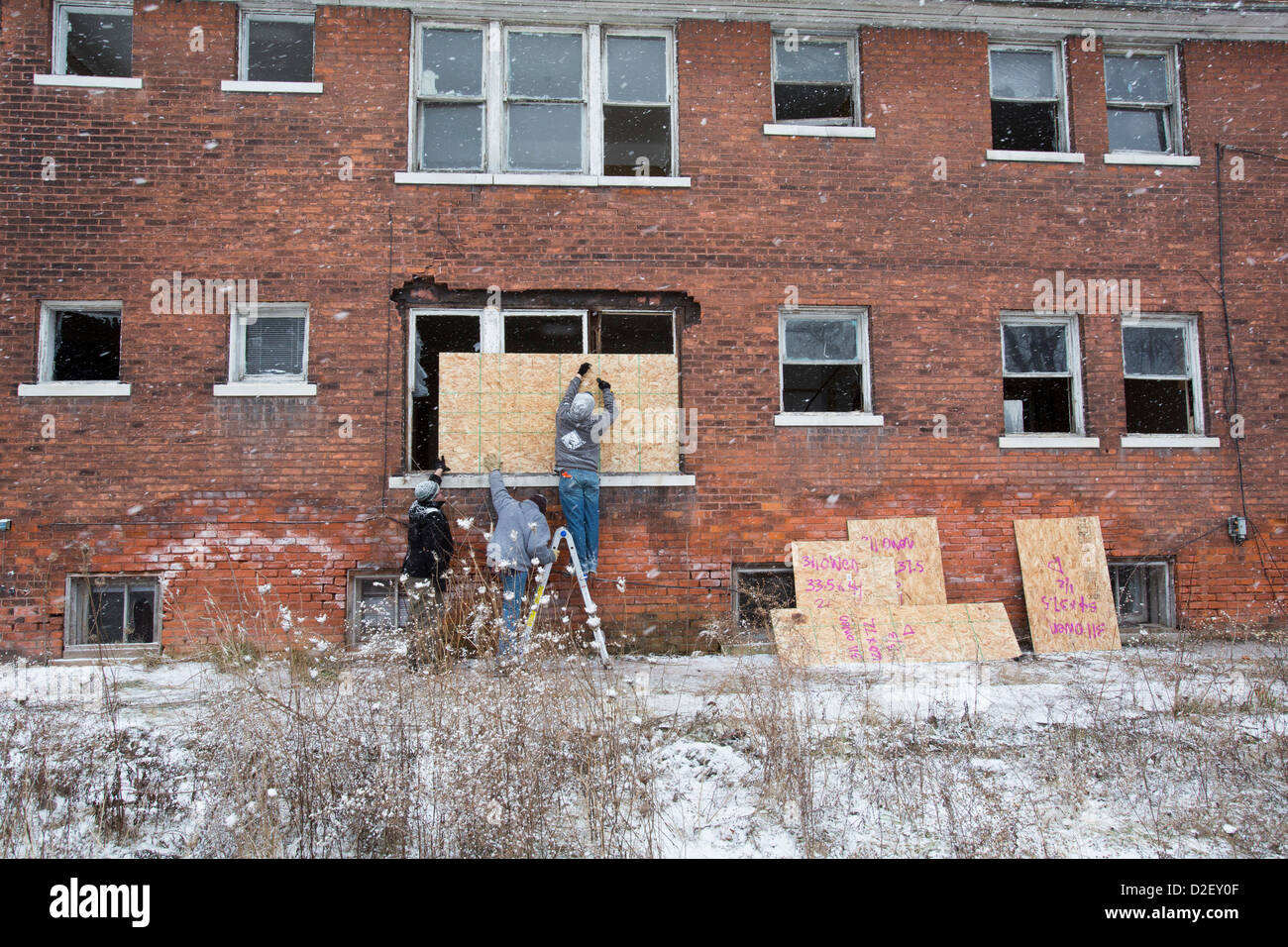 On Martin Luther King Jr. Day, volunteers from Wayne State University and neighborhood residents boarded up abandoned houses. Stock Photo
