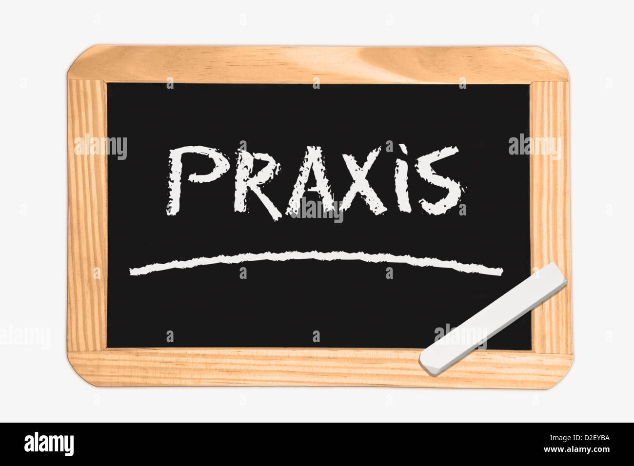 Detail photo of a Chalkboard with the German inscription practice, white chalk lies in a corner Stock Photo