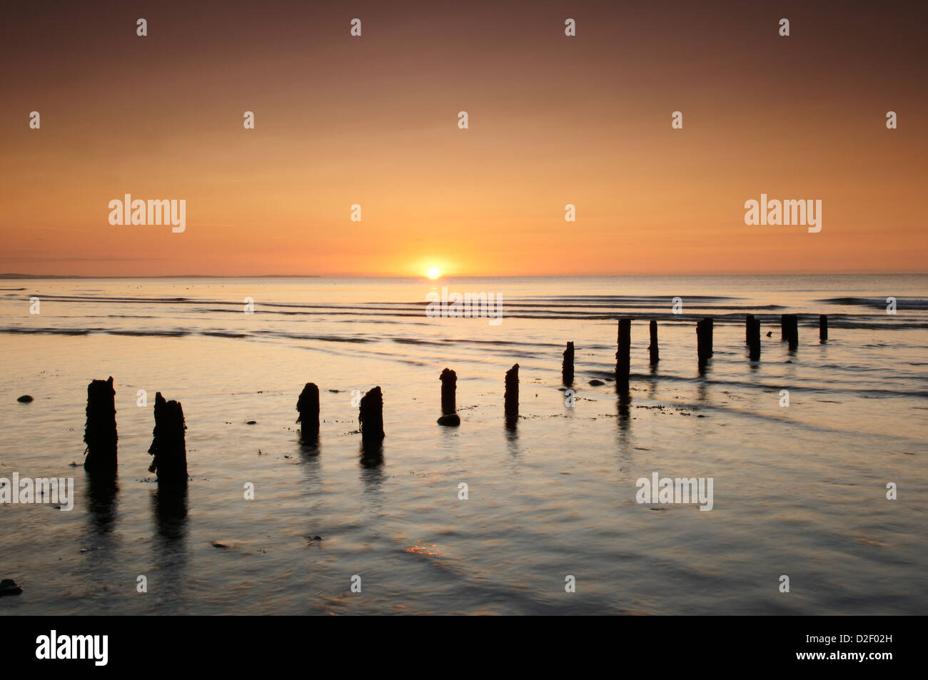Sunrise over Newcastle beach Count Down Northern Ireland and remains of