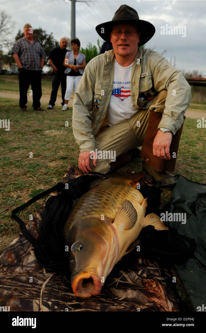 Man with big a common carp (Cyprinus carpio) at Lady Bird Lake, Austin Texas Stock Photo