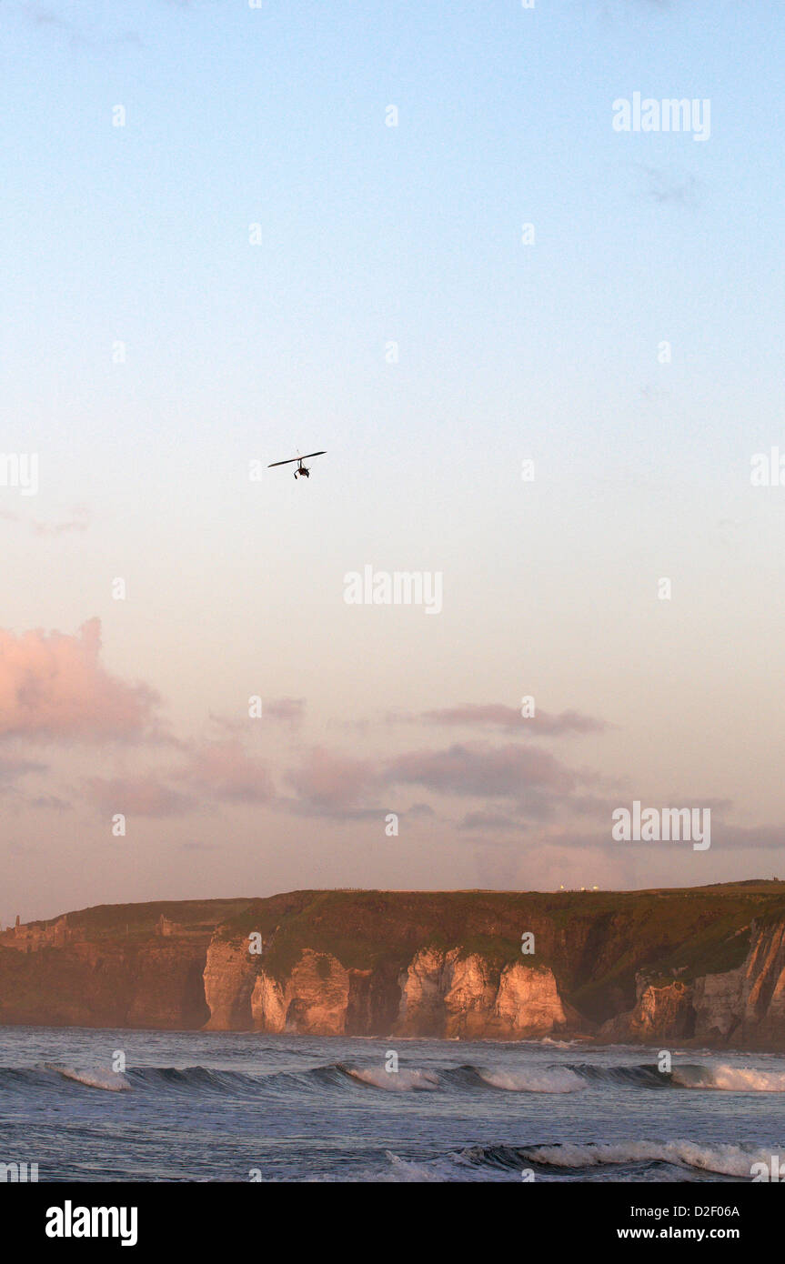 Autogyro / Gyroplane flying over cliffs Whiterocks beach North Antrim Coast Stock Photo