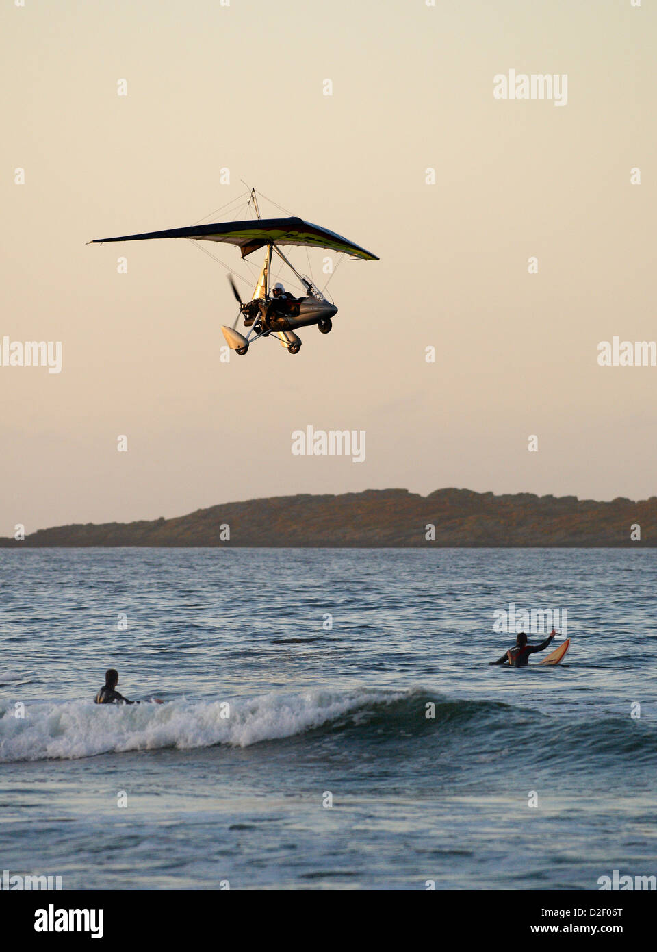 Autogyro / Gyroplane flying over People walking along Whiterocks beach North Antrim Coast Stock Photo