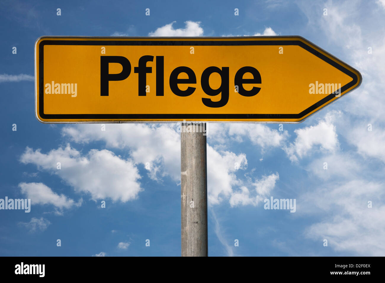 Detailansicht eines Wegweisers mit der Aufschrift Pflege | Detail photo of a signpost with the German inscription care Stock Photo