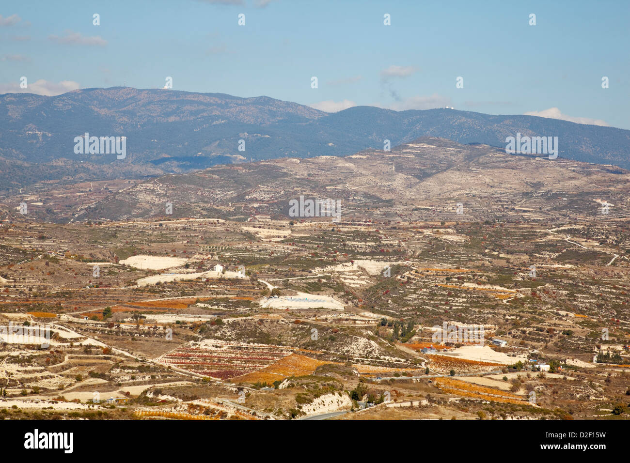 Overlooking dry grape vine terraces in the Troodos Foothills, Cyprus. The signals golf balls on Mount Olympus can be seen on the Stock Photo