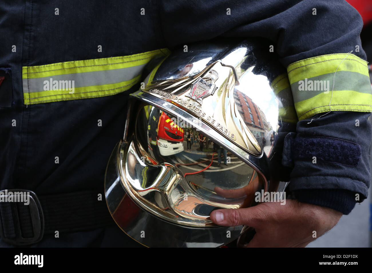 Firefighter carrying his helmet Paris. France Stock Photo - Alamy