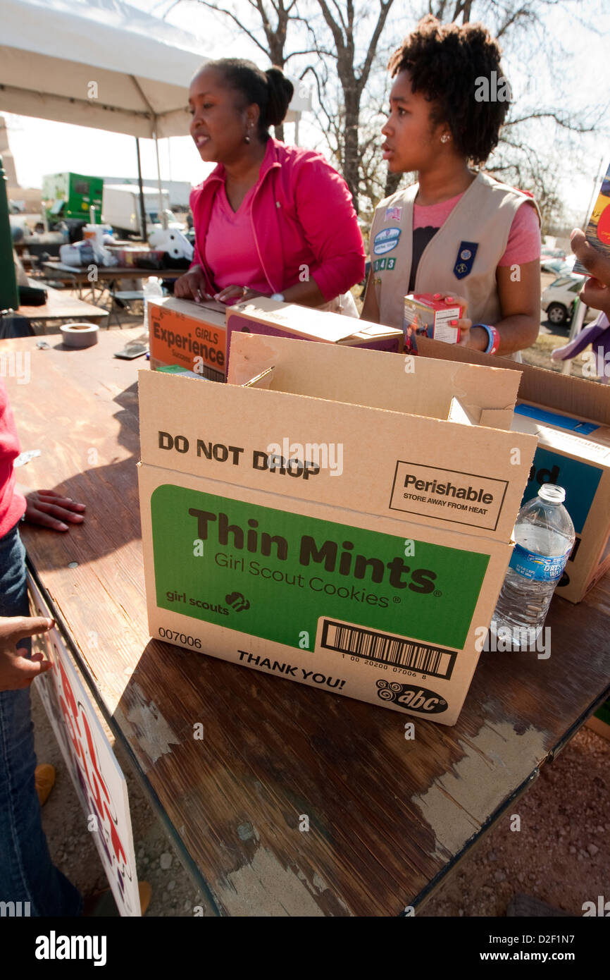 Young African-American girl scouts set up table to sell cookies at outdoor MLK festival in Austin, Texas Stock Photo