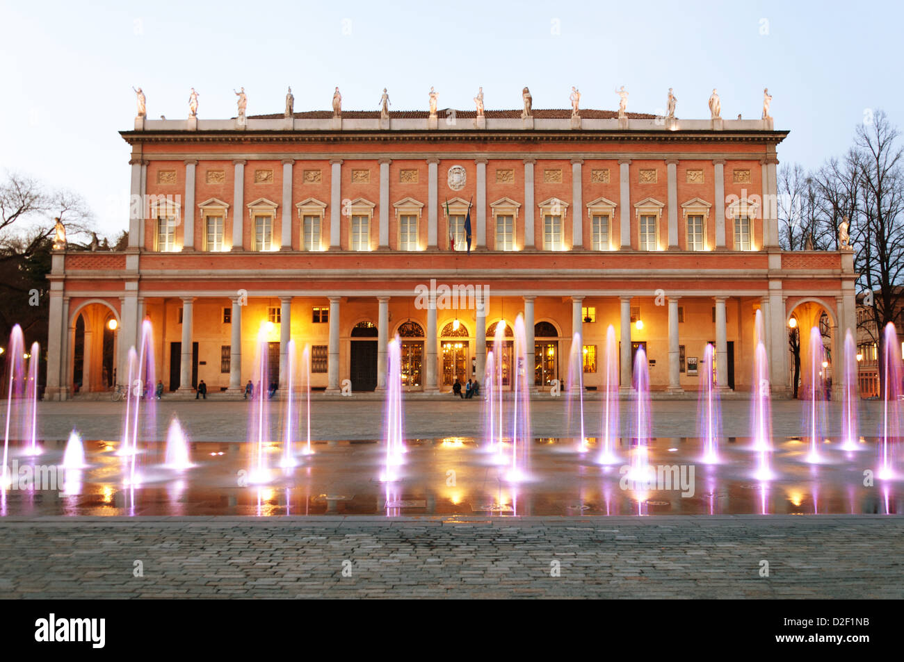 day view of 'Romolo Valli' Municipal Theater in Reggio Emilia, north of Italy, with enlightened modern fountain Stock Photo