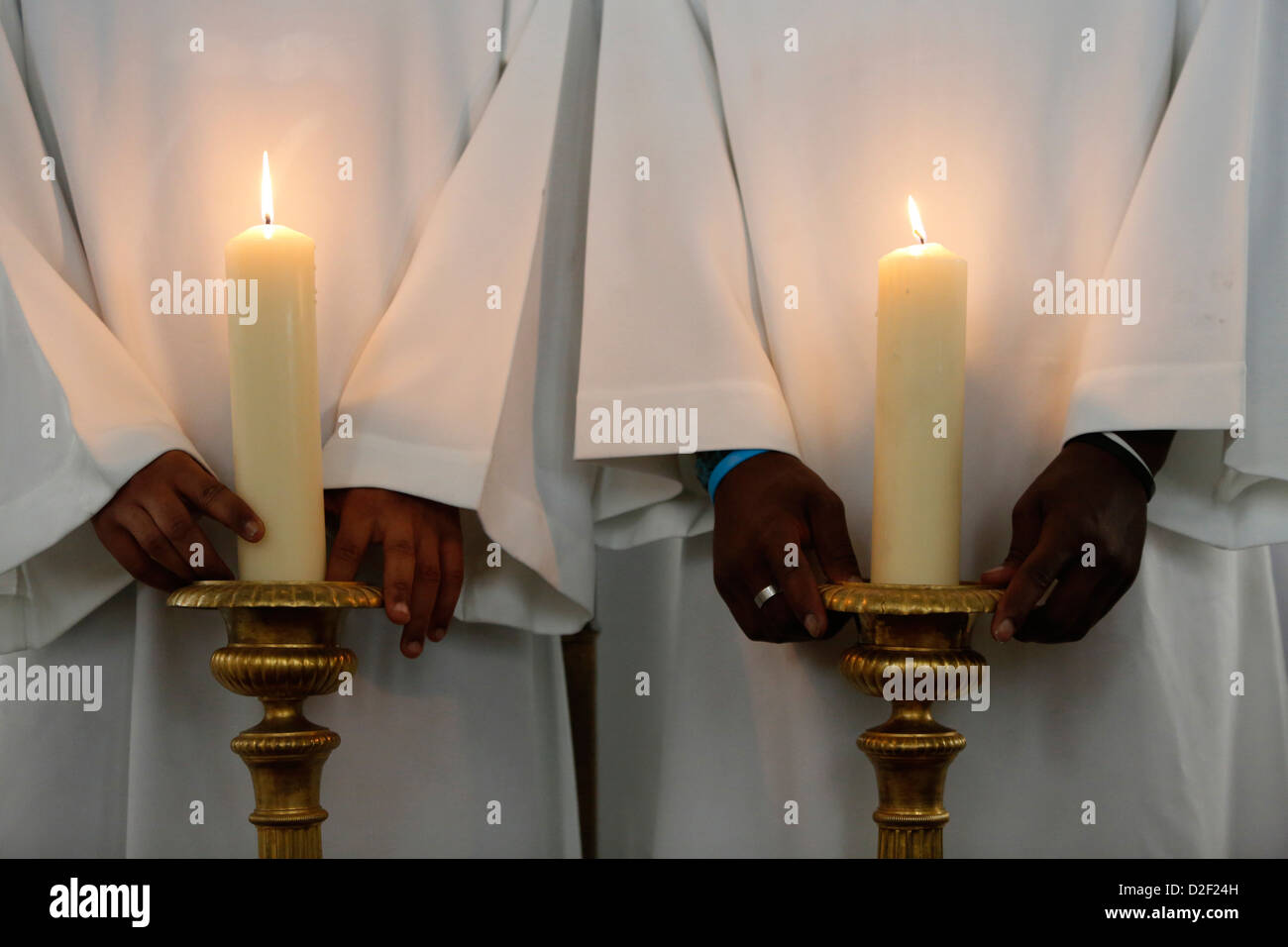 Catholic altar boys holding church candles for procession Stock Photo