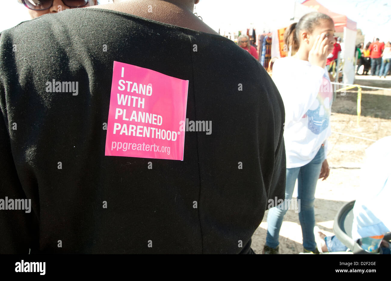 Planned Parenthood items include pens, stickers placed on shirts at information booth during MLK outdoor festival in Austin, TX Stock Photo
