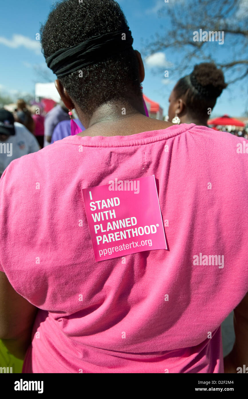 Planned Parenthood items include pens, stickers placed on shirts at information booth during MLK outdoor festival in Austin, TX Stock Photo