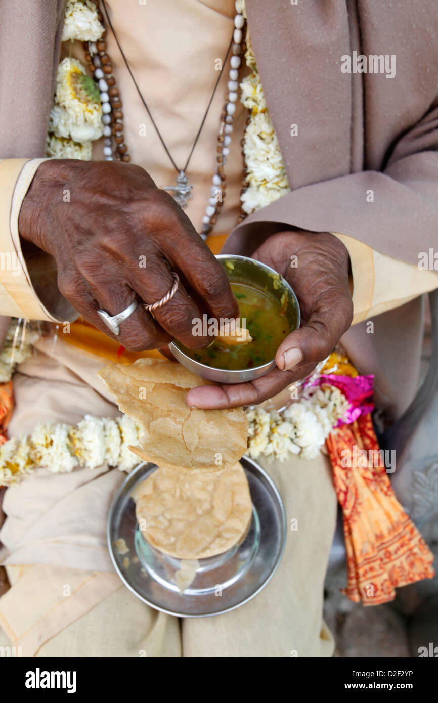 Sadhu eating vegetarian food Dauji. India. Stock Photo
