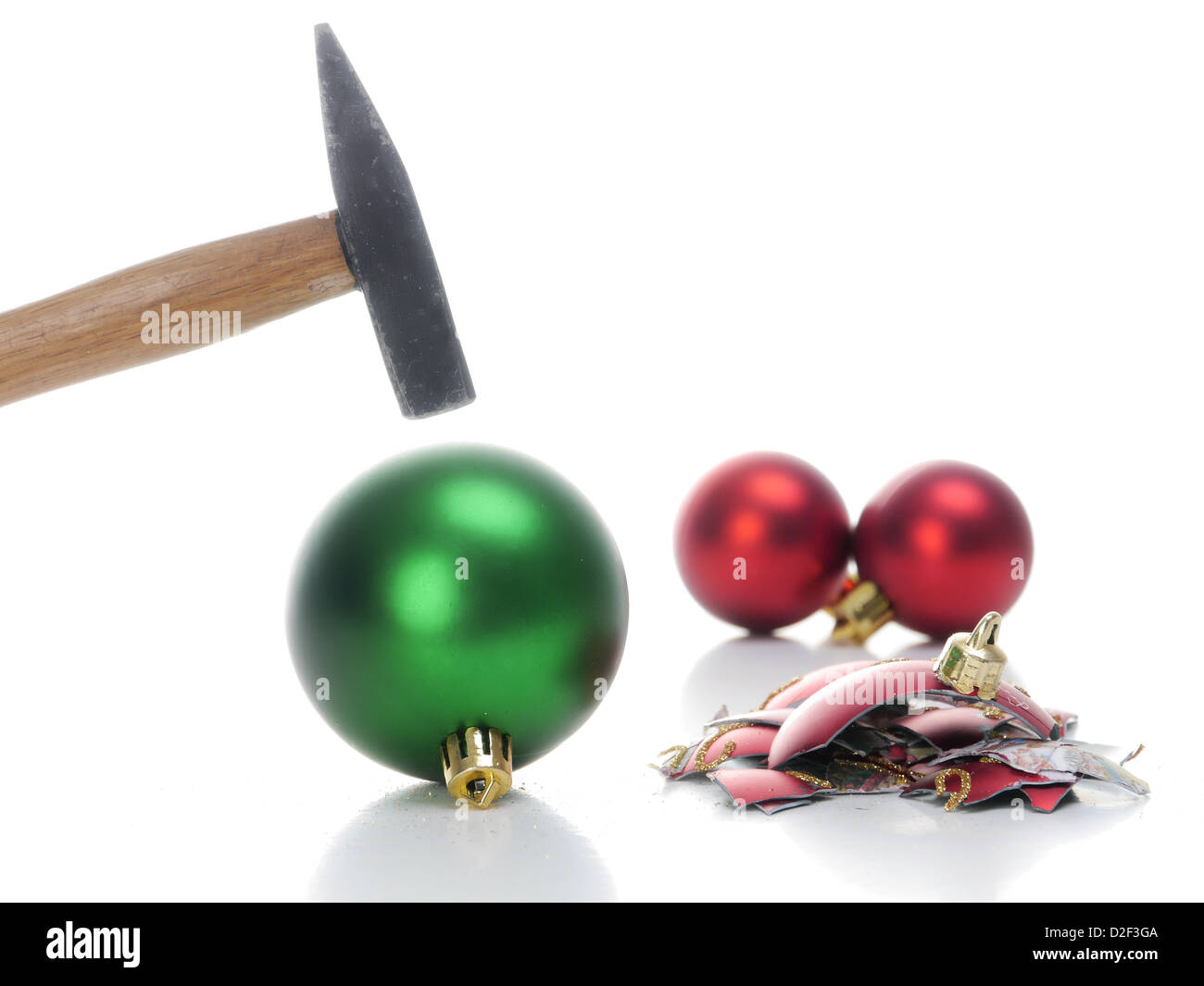 Hammer hitting christmas ball breaking it into pieces - concept depicting aversion to celebrate christmas holidays Stock Photo