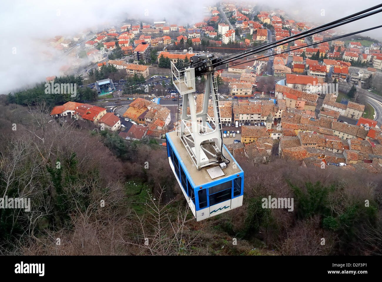 Serenissima Repubblica di San Marino. January 21, 2013 , The territory of San Marino Republic was covered up with a thick coat of clouds. Only the towers on Mount Titano pierced  the clouds. The ropeway. Credit: Ferdinando Piezzi Stock Photo