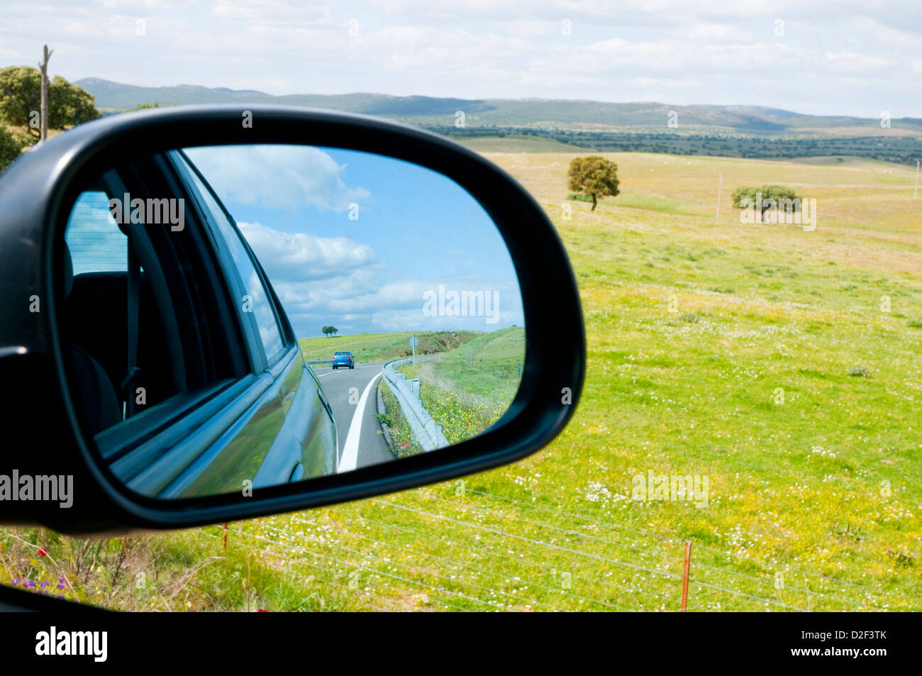 Side road viewed across the rear view mirror. Alcudia valley, Ciudad Real province, Castilla La Mancha, Spain. Stock Photo