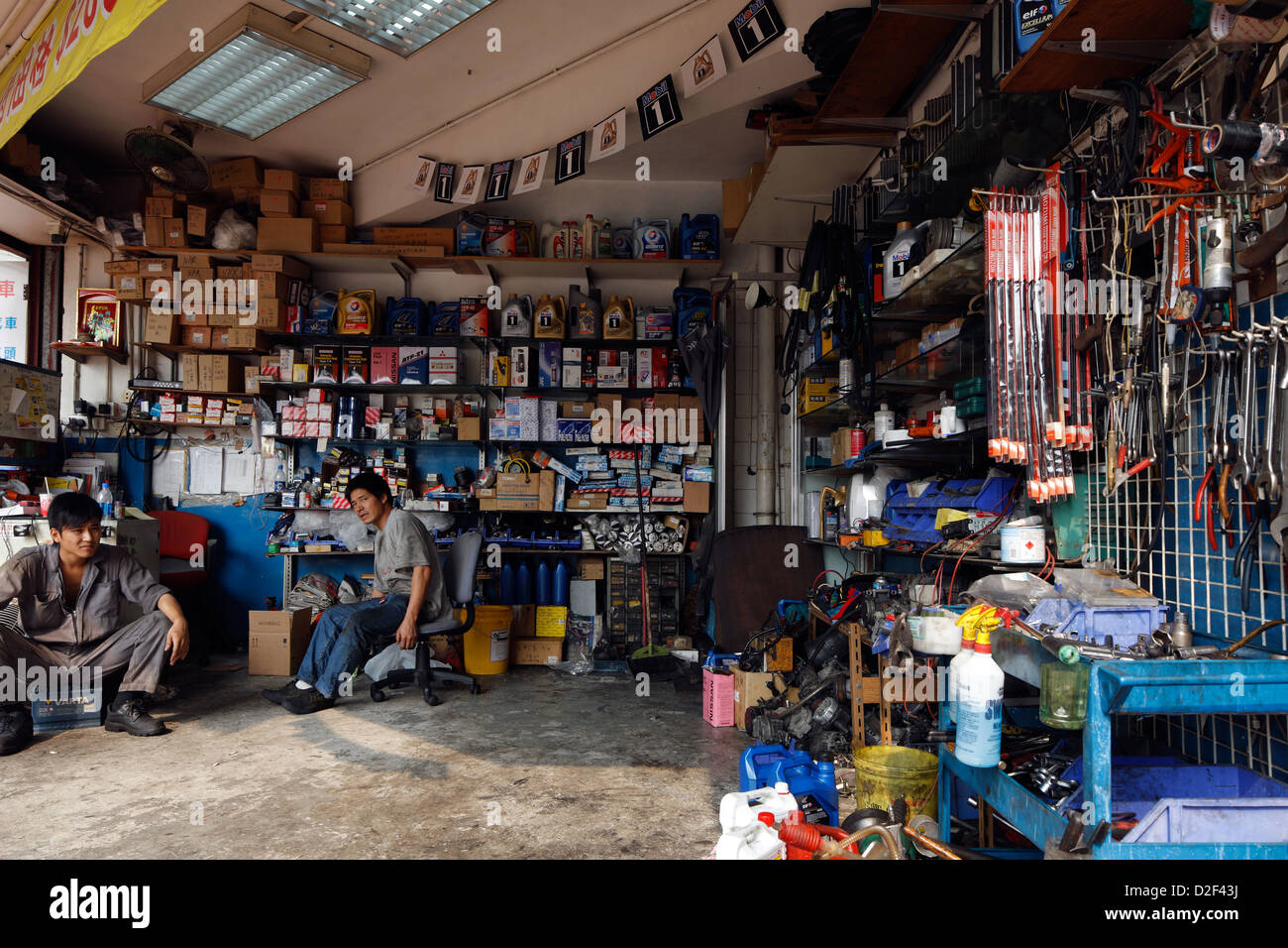 Hong Kong, China, two mechanics in a auto repair shop in Hong Kong