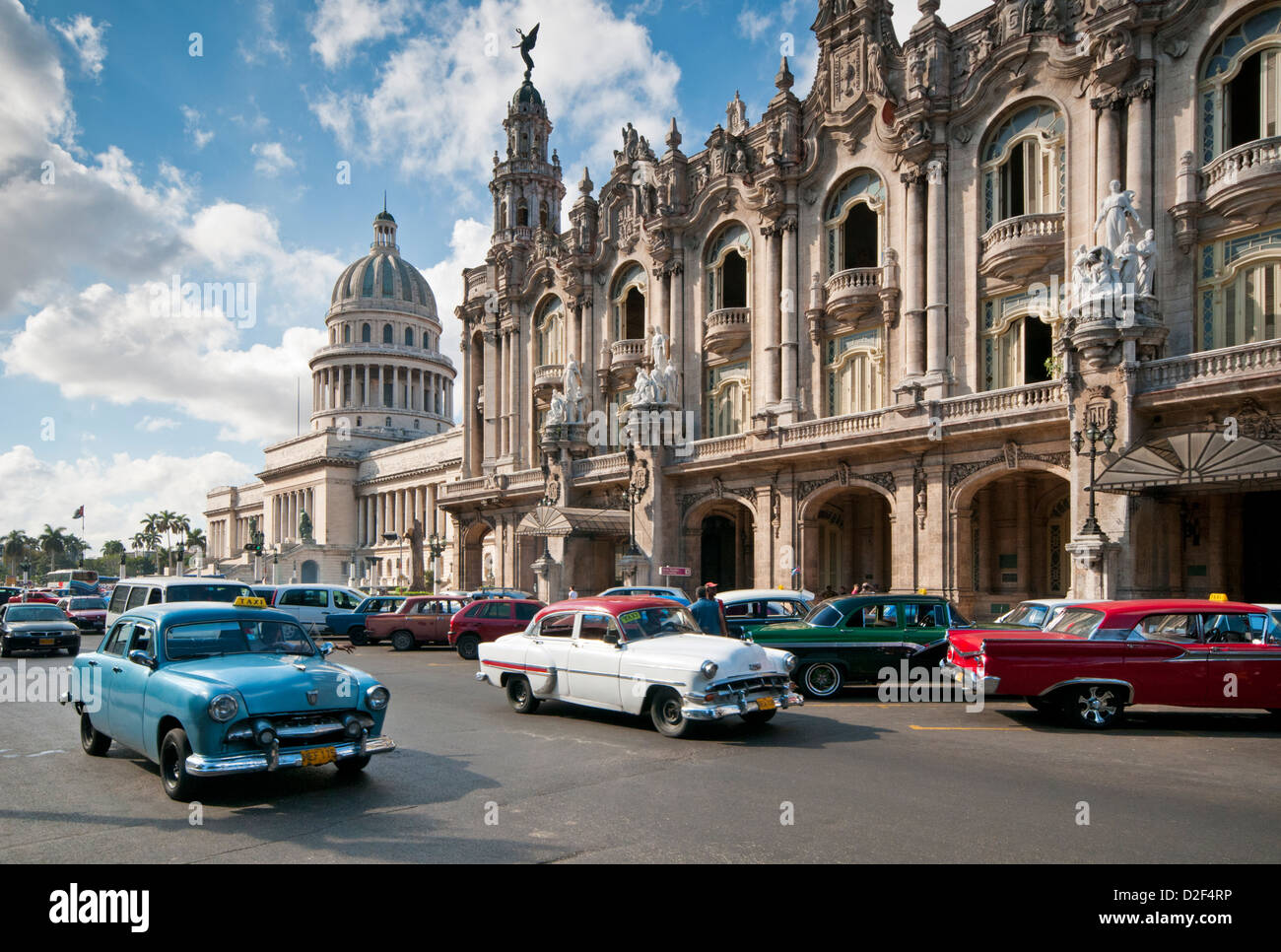Classic 1950's American Car Passing The Capitolio Building and Gran Teatro de la Habana, Paseo de Marti, Havana, Cuba Stock Photo