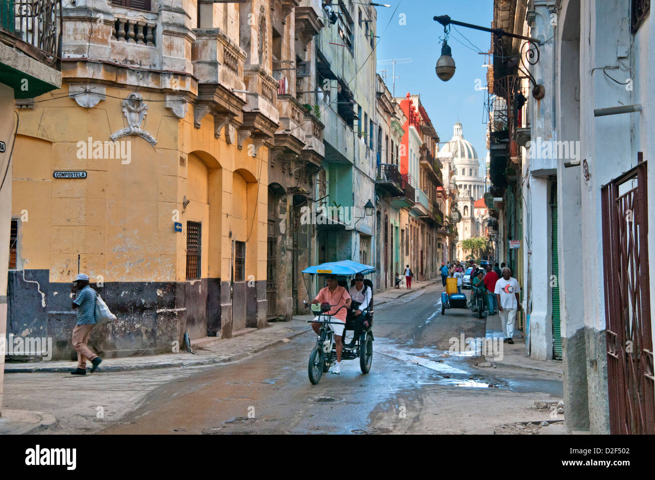 A Bicitaxi or Bicycle Rickshaw Taxi on Calle Brazil, with Capitolio Building behind, Habana Vieja, Havana, Cuba, Caribbean Stock Photo