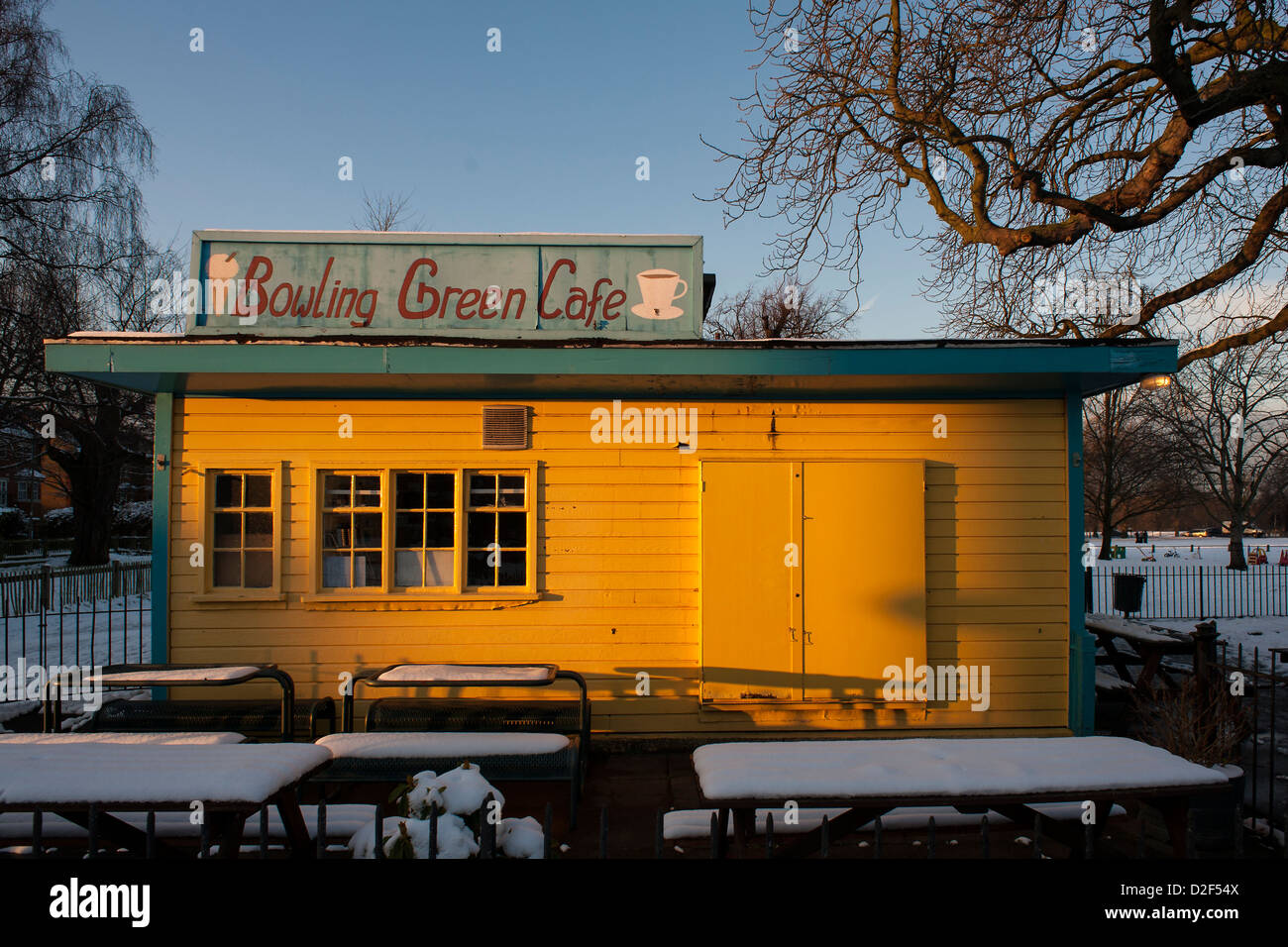 The Bowling Green Cafe is bathed in golden sunlight despite being closed in the snow Stock Photo