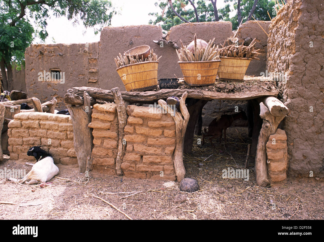 Shelter for the goats in a village on the Dogon Plateau in Mali, West Africa. Millet and sorghum is being dried on the roof. Stock Photo