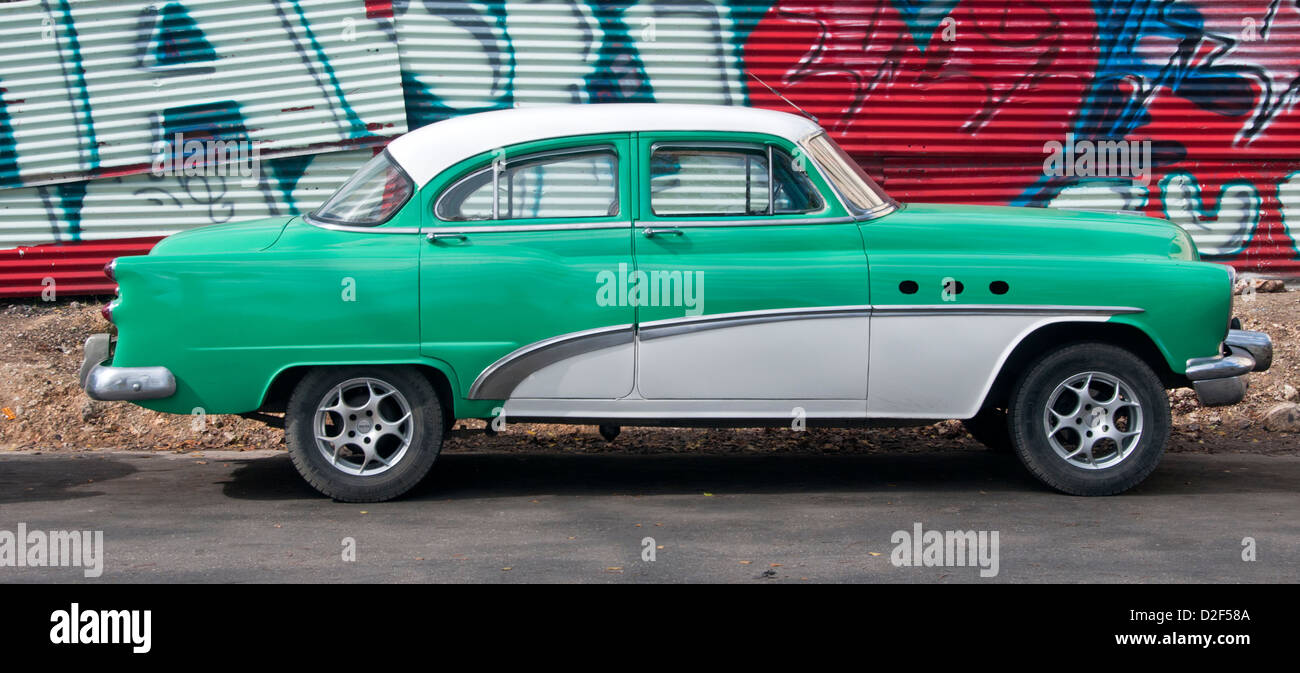 Classic American 1950's Car in front of Graffiti Wall on the Streets of Havana, Havana, Cuba Stock Photo