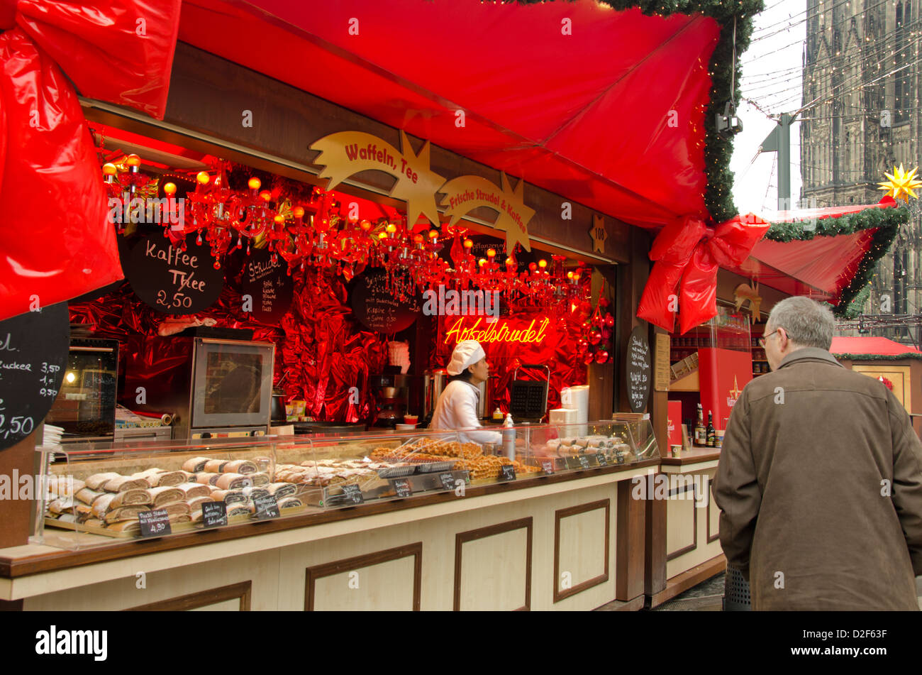 Germany, Cologne. Cologne Cathedral Christmas Market. Annual holiday market bread vendor stand. Stock Photo