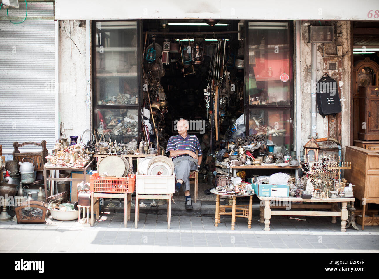 An elderly man sits in the sun outside of his shop in the old town of Jaffa near Tel Aviv, Israel. Stock Photo