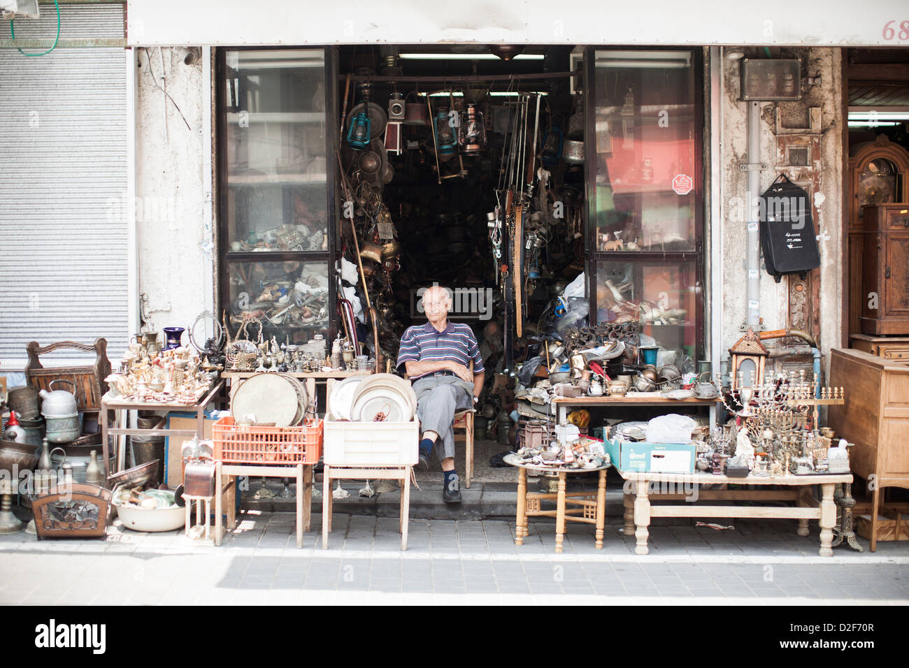 An elderly man sits in the sun outside of his shop in the old town of Jaffa near Tel Aviv, Israel. Stock Photo