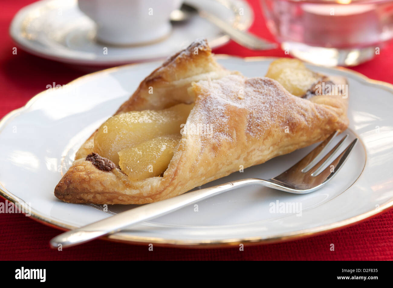 Puff pastry with pears, a chocolate hazelnut spread and walnuts. Stock Photo
