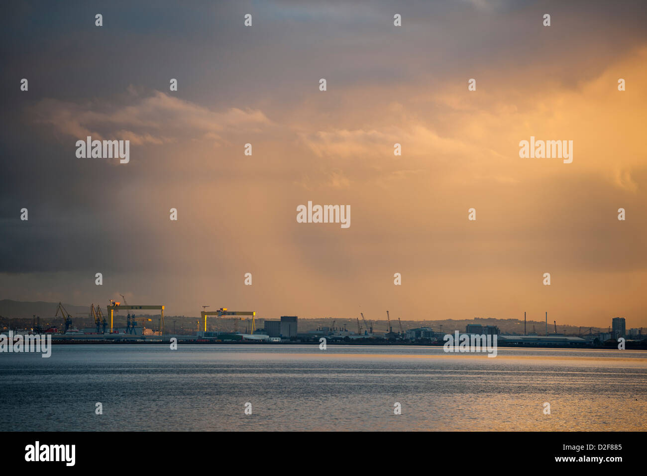 Belfast harbour at sunset with Mountains of Mourne in background Stock Photo