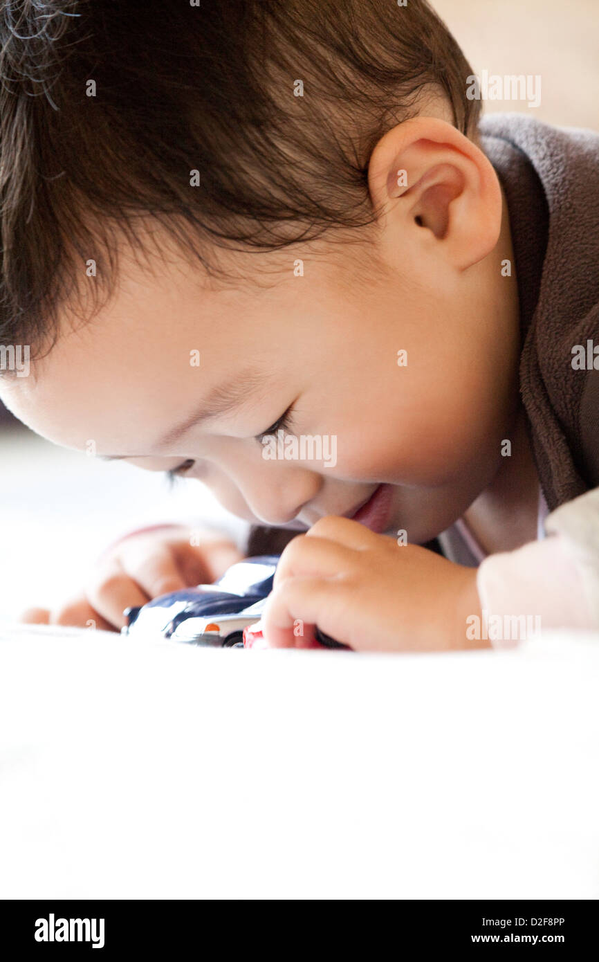 Cute little boy playing a toy car Stock Photo - Alamy