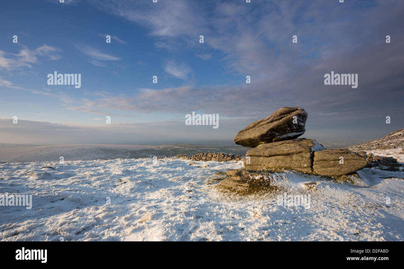 Logan stone on Belstone Tor with a light covering of snow in January, Dartmoor National Park Devon Uk Stock Photo