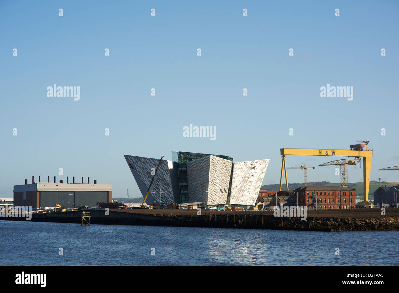 Belfasts new Titanic Visitors centre at the final stages of construction with on of Harland and Wolffs giant cranes Stock Photo